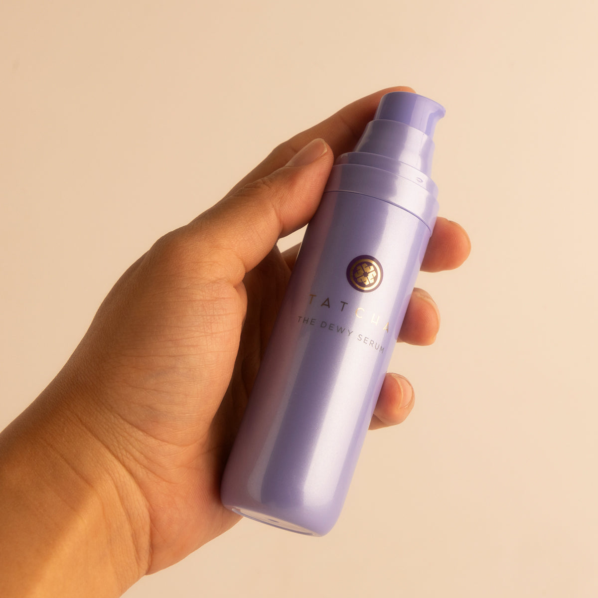 Hand holding the Dewy Serum