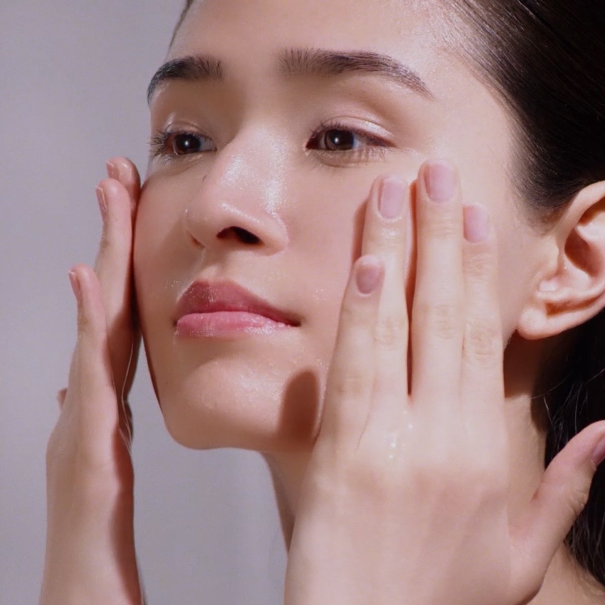 Woman washing with Camellia Cleansing Oil