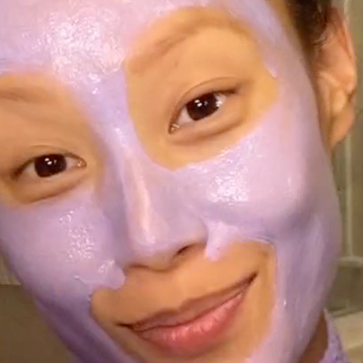 Shot of model with Violet-C Radiance Mask applied to face.